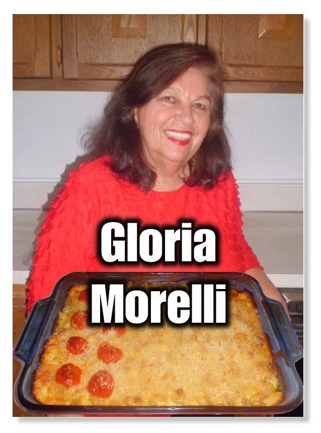 Gloria Morelli holding a tray of baked pasta.