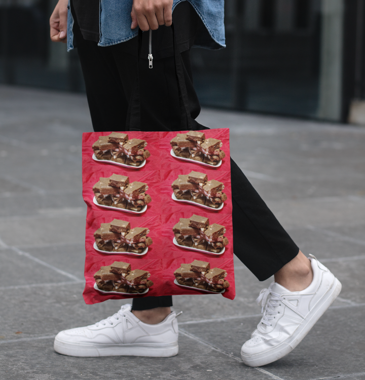 Man holding a Cherry Chocolate Marshmallow Fudge On A Plate tote bag.