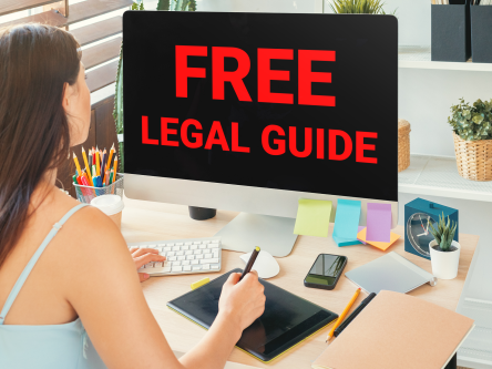 Woman looking at a computer screen that reads: Free Legal Guide.