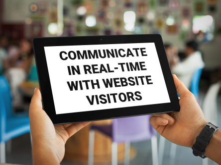 Man looking at a computer tablet that reads: Communicate In Real-Time With Website Visitors.